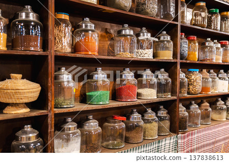 Traditional bedouin herbal pharmacy shelves with glass jars of medicinal herbs spices and natural remedies Traditional bedouin herbal pharmacy shelves with glass jars of medicinal herbs spices and natural remedies 137838613