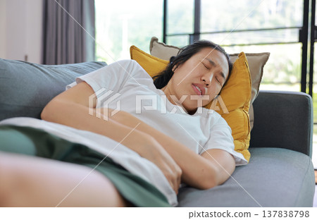 Woman holding her stomach with red highlight. Abdominal pain, liver disease, kidney pain, appendicitis and stomach ache concept for health care and medical treatment. Woman holding her stomach with red highlight. Abdominal pain, liver disease, kidney pain, appendicitis and stomach ache concept for health care and medical treatment. 137838798
