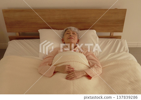 Senior woman sleeping in bedroom 137839286