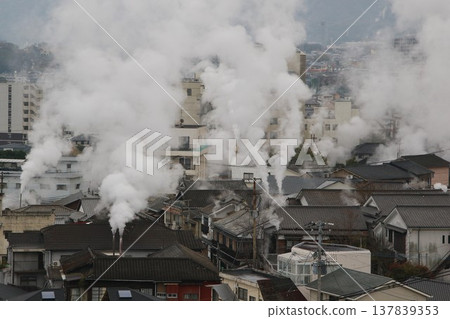 Steam rising from Kannawa Onsen and the hot spring town on a rainy day in March. 137839353