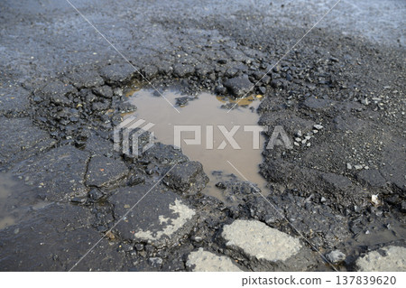 Potholes (holes in the asphalt) in the road 137839620