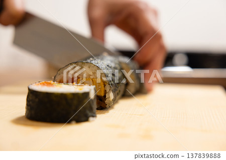 Close-up of a woman's hands making Ehomaki (lucky direction sushi roll). 137839888