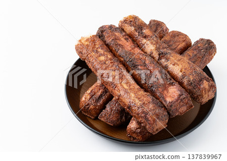 Brown sugar puffed rice snacks on a plate against a white background Brown sugar puffed rice snacks on a plate against a white background 137839967