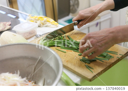 A woman cutting Chinese chives A woman cutting Chinese chives 137840019