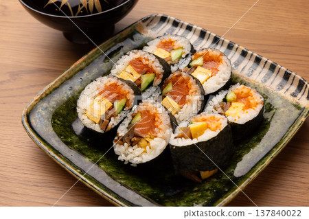 Sushi rolls cut and served on a plate 137840022