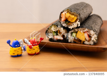 Setsubun Ehomaki (lucky direction sushi roll) and figurines of a red demon and a blue demon Setsubun Ehomaki (lucky direction sushi roll) and figurines of a red demon and a blue demon 137840095