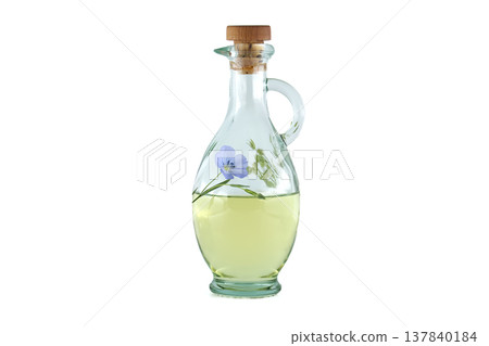 Glass bottle filled with golden flaxseed oil and a delicate blue flax flower inside Glass bottle filled with golden flaxseed oil and a delicate blue flax flower inside 137840184