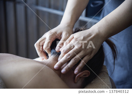 Close up Massage Thai Spa head therapy Massaging neck shoulder stretching pain relief. Woman office syndrome therapy relax treatment spa salon. Women therapist headache relief pain head massage Close up Massage Thai Spa head therapy Massaging neck shoulder stretching pain relief. Woman office syndrome therapy relax treatment spa salon. Women therapist headache relief pain head massage 137840312