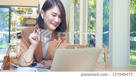 Happy asian woman video call web conference sitting on cozy sofa in living room at home. Smile Female asian people use laptop notebook computer headphones online call working from home watching video Happy asian woman video call web conference sitting on cozy sofa in living room at home. Smile Female asian people use laptop notebook computer headphones online call working from home watching video 137840475