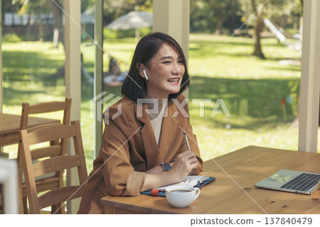 Happy asian woman video call web conference sitting on cozy sofa in living room at home. Smile Female asian people use laptop notebook computer headphones online call working from home watching video Happy asian woman video call web conference sitting on cozy sofa in living room at home. Smile Female asian people use laptop notebook computer headphones online call working from home watching video 137840479