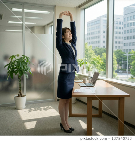 A woman in a business suit trying to look more mature than she is. 137840733