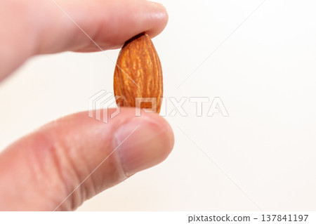 Almonds pinched with fingers Almonds pinched with fingers 137841197