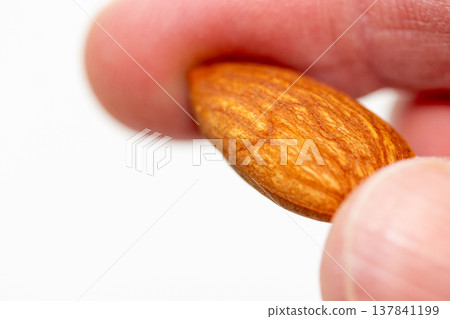 Almonds pinched with fingers Almonds pinched with fingers 137841199