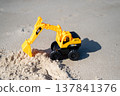 A sandy beach and a toy excavator 137841376