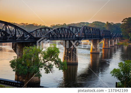 Landscape of Bridge River Kwai at Kanchanaburi, Thailand in sunset time. Is a famous place and a tourist destination Landscape of Bridge River Kwai at Kanchanaburi, Thailand in sunset time. Is a famous place and a tourist destination 137842199