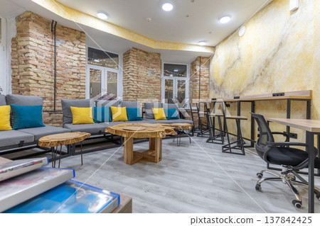 Industrial Hostel Lounge with Coworking Area and Slab Tables 137842425