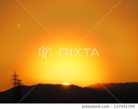 Orange evening sky and the sun setting over the Kanto Mountains 137842704