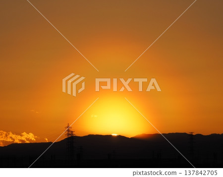Orange evening sky and the sun setting over the Kanto Mountains Orange evening sky and the sun setting over the Kanto Mountains 137842705