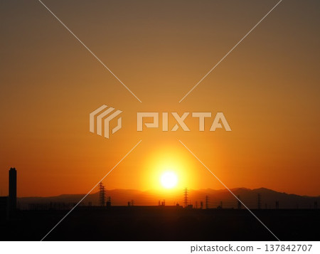 Orange evening sky and the sun setting over the Kanto Mountains Orange evening sky and the sun setting over the Kanto Mountains 137842707
