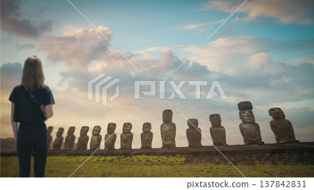 Woman Looking at Moai Statues on Easter Island at Sunset with copy space Woman Looking at Moai Statues on Easter Island at Sunset with copy space 137842831