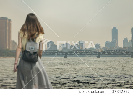 Woman Traveler Looking at Cairo City Skyline and Nile River Woman Traveler Looking at Cairo City Skyline and Nile River 137842832