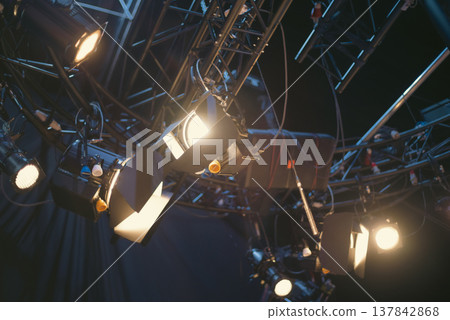 Professional Stage Lighting Spotlights on Metal Truss in Dark Studio with copy space Professional Stage Lighting Spotlights on Metal Truss in Dark Studio with copy space 137842868