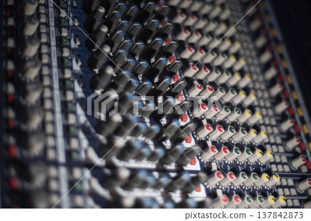 Close-up of professional audio mixing console with colorful knobs in studio with copy space 137842873