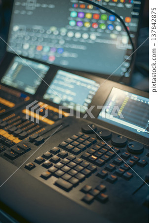 Professional Lighting Control Console with Touch Screens in Dark Studio with copy space 137842875