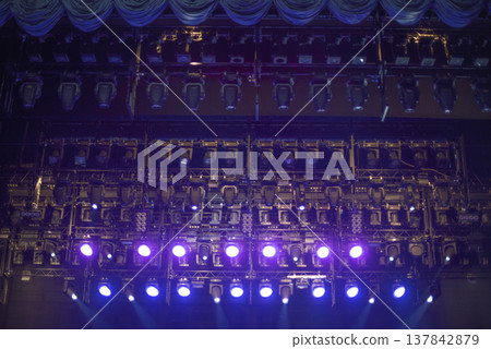 Professional Stage Lighting Rig with Purple and Blue Spotlights in Dark with copy space 137842879