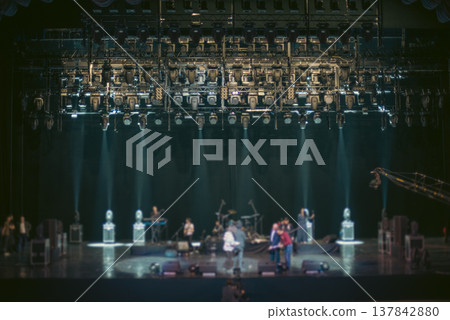 Concert Stage with Professional Lighting Rig and Crew during Soundcheck with copy space 137842880