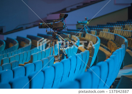 Professional TV camera in empty concert hall for live streaming with copy space Professional TV camera in empty concert hall for live streaming with copy space 137842887