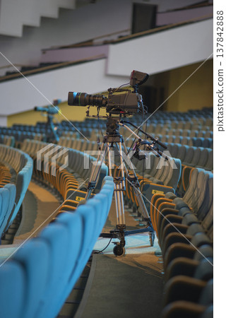 Professional broadcasting camera in empty auditorium for live event with copy space Professional broadcasting camera in empty auditorium for live event with copy space 137842888