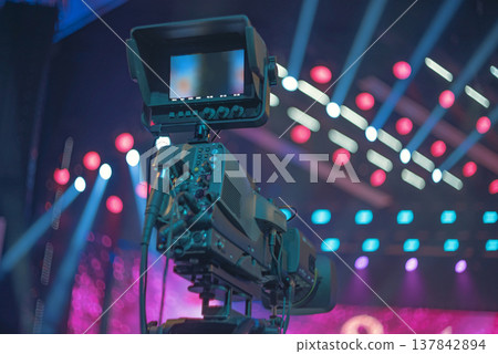 Professional TV camera with monitor on stage background with copy space Professional TV camera with monitor on stage background with copy space 137842894