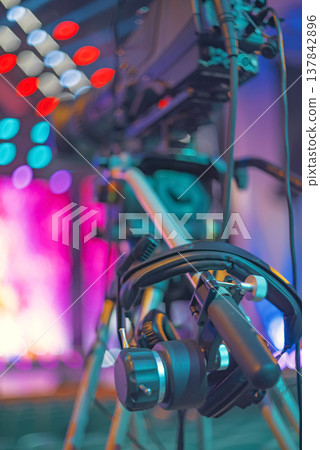 Professional Broadcast TV Camera Setup on Tripod with Stage Bokeh and Copy Space Professional Broadcast TV Camera Setup on Tripod with Stage Bokeh and Copy Space 137842896