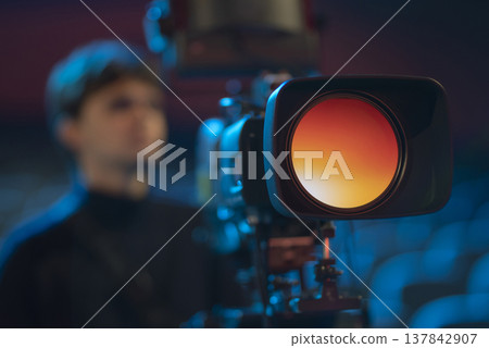Close-up of professional video camera lens with orange reflection and copy Close-up of professional video camera lens with orange reflection and copy 137842907