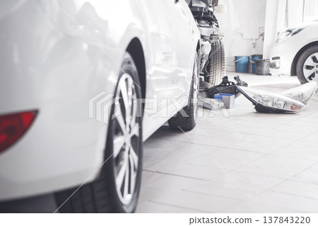 Replacing the front lights on car in service station. 137843220