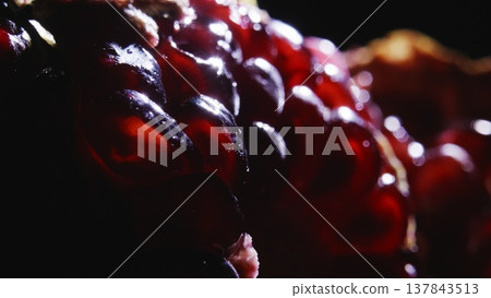 A juicy red pomegranate in the sun's rays. 137843513