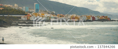 Person walking on black sand beach Playa Jardin in Puerto de la Cruz Tenerife with copy space Person walking on black sand beach Playa Jardin in Puerto de la Cruz Tenerife with copy space 137844266