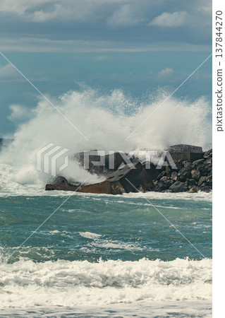 Massive Powerful Atlantic Ocean Wave Crashing Over Concrete Barrier with copy space Massive Powerful Atlantic Ocean Wave Crashing Over Concrete Barrier with copy space 137844270