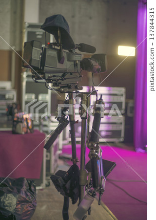 Professional Steadicam System with Camera in Neon Concert Lighting with copy space 137844315