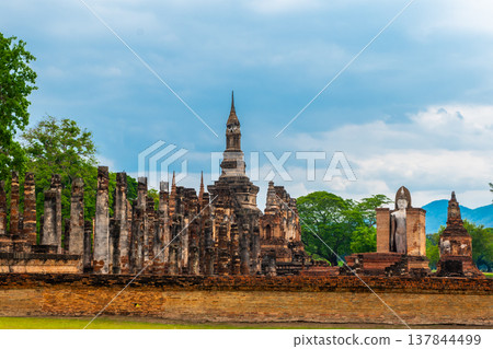 Landscape of Buddha statue and pagoda in Wat Mahathat temple Sukhothai Historical Park, Thailand Landscape of Buddha statue and pagoda in Wat Mahathat temple Sukhothai Historical Park, Thailand 137844499