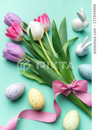 Easter tulips bouquet with eggs and bunnies on pastel background 137844868