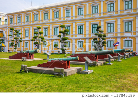 Ancient cannons are lined up in front of the Thai Ministry of Defense in Bangkok, opposite the Grand Palace of Wat Phra Kaew. Ancient cannons are lined up in front of the Thai Ministry of Defense in Bangkok, opposite the Grand Palace of Wat Phra Kaew. 137845189