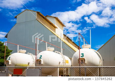 Large gas tanks are used in industrial plants for production. Large gas tanks are used in industrial plants for production. 137845262