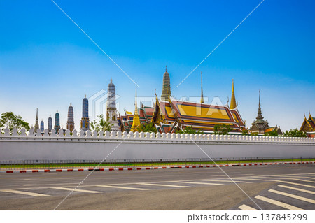Bangkok Temple Wat Phra Kaew is in the Royal Palace of Thailand with blue sky background. It is a popular place and destination for tourists around the world. Bangkok Temple Wat Phra Kaew is in the Royal Palace of Thailand with blue sky background. It is a popular place and destination for tourists around the world. 137845299