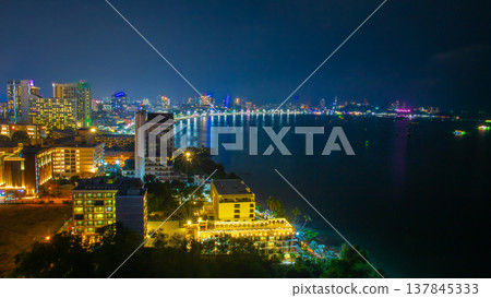 Panoramic view of Pattaya city from high angle with beach and buildings in night time. It is a landmark and popular tourist destination. Panoramic view of Pattaya city from high angle with beach and buildings in night time. It is a landmark and popular tourist destination. 137845333