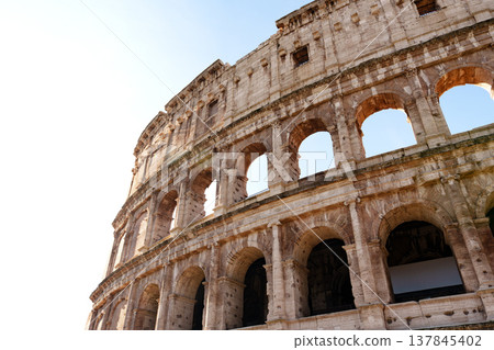 Explore the ancient architecture of the Colosseum in Rome during a sunny day 137845402