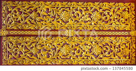 The golden Thai wood carvings commonly found in temples and important buildings in Thailand are traditional Thai art. The golden Thai wood carvings commonly found in temples and important buildings in Thailand are traditional Thai art. 137845580