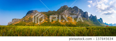 Beautiful Panorama landscape of mountain with grass field and blue sky range background in Khao Sam Roi Yot National Park, Kui Buri District, Prachuap Khiri Khan, Thailand Beautiful Panorama landscape of mountain with grass field and blue sky range background in Khao Sam Roi Yot National Park, Kui Buri District, Prachuap Khiri Khan, Thailand 137845634