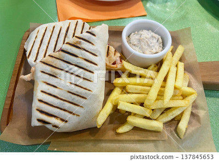 Shawarma with tartar sauce and French fries Shawarma with tartar sauce and French fries 137845653